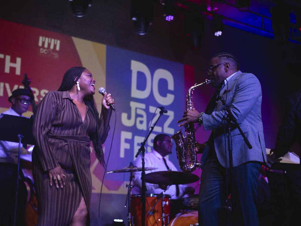 Christie Dashiell sings and Antonio Hart plays saxophone with the JazzDC All-Stars on opening night of DC JazzFest at The Hamilton Live in Washington, D.C.