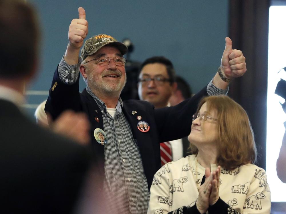 John Haggard, a returning pro-Trump elector in Michigan who faces eight felony counts related to submitting a false certificate in 2020, gives two thumbs up after the state’s governor announces all of Michigan’s electoral votes for Trump in 2016 in Lansing, Mich.