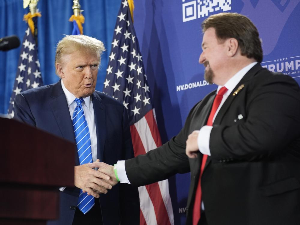 Michael McDonald, the chair of Nevada’s Republican Party, shakes hands with former President Donald Trump at a January event for Trump’s reelection campaign in Las Vegas. McDonald is one of this year’s 14 presidential electors who are linked to efforts to reverse Trump’s 2020 defeat.