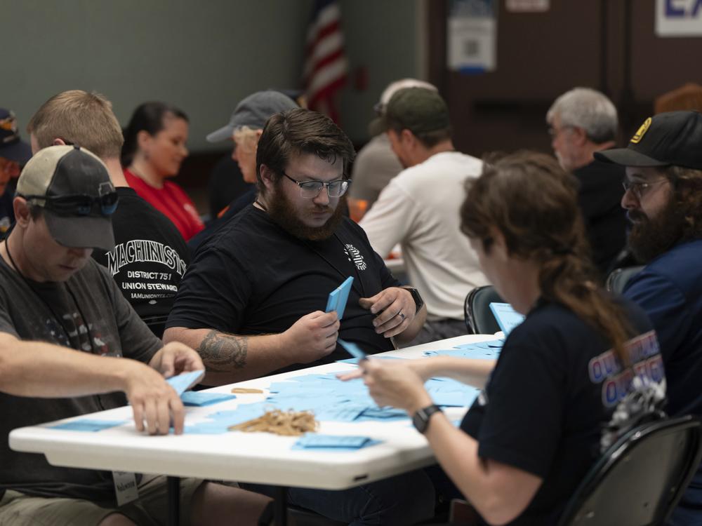 Members of the International Aerospace Machinists count votes on a contract offer by airplane maker Boeing on Thursday in Seattle. More than 94% of union members rejected the contract and authorized a strike.