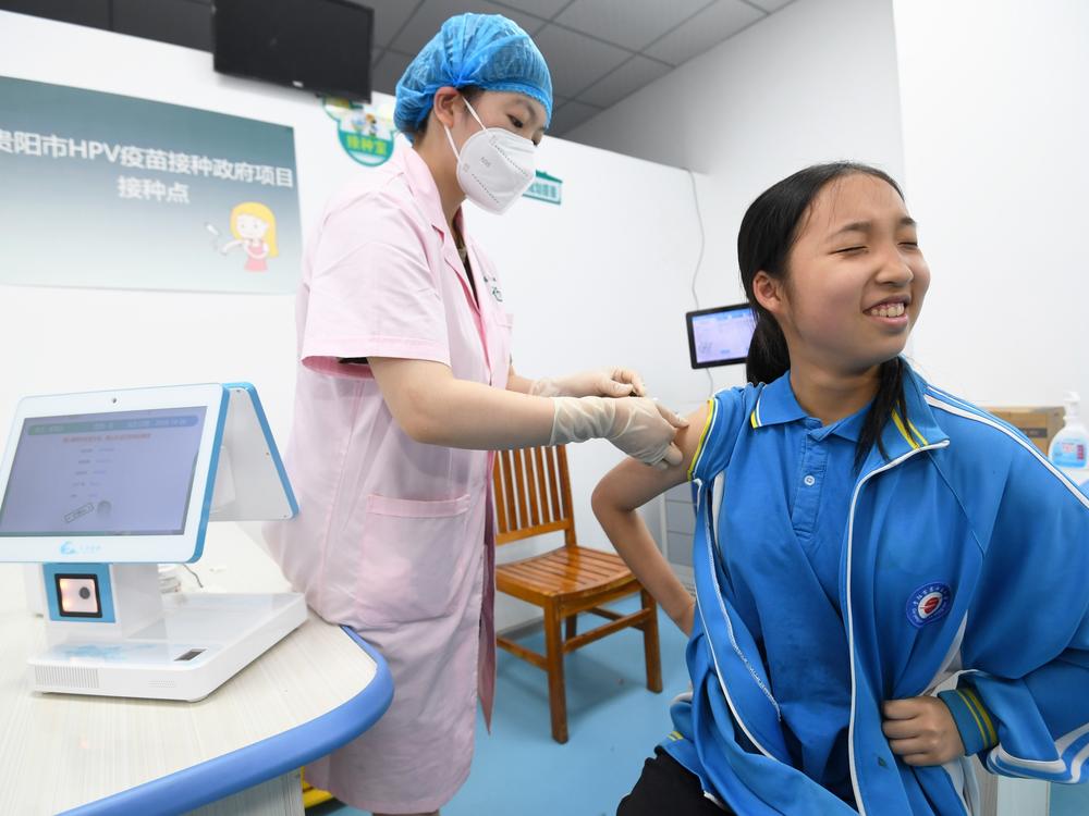 A schoolgirl receives a dose of HPV vaccine at a community health service center in Guiyang, Guizhou province, China.