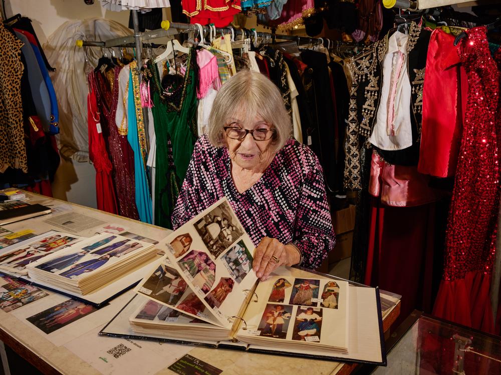 Boschet flips through a lookbook full of her custom designs.