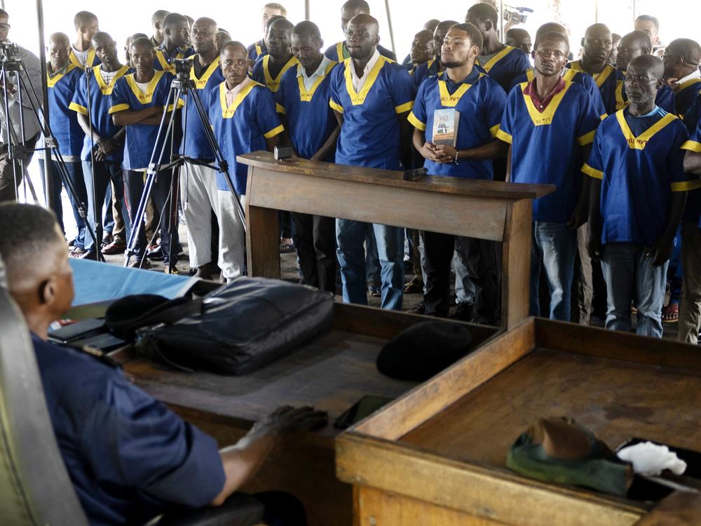 American Marcel Malanga, fourth right, stands with others during a court verdict in DRC, Kinshasa, Friday Sept .13, 2024, on charges of taking part in a coup attempt in May 2024. 