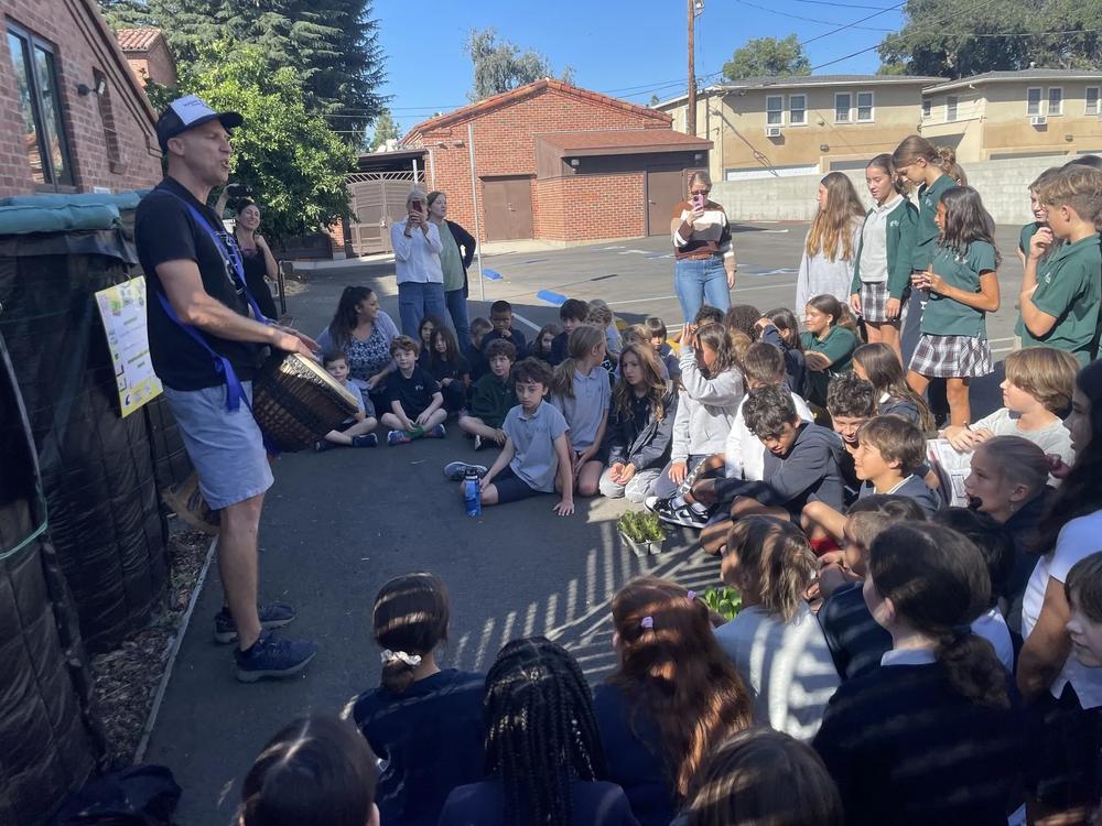  Steven Wynbrandt leads students at The Wesley School through its first-ever compost harvesting ceremony. 