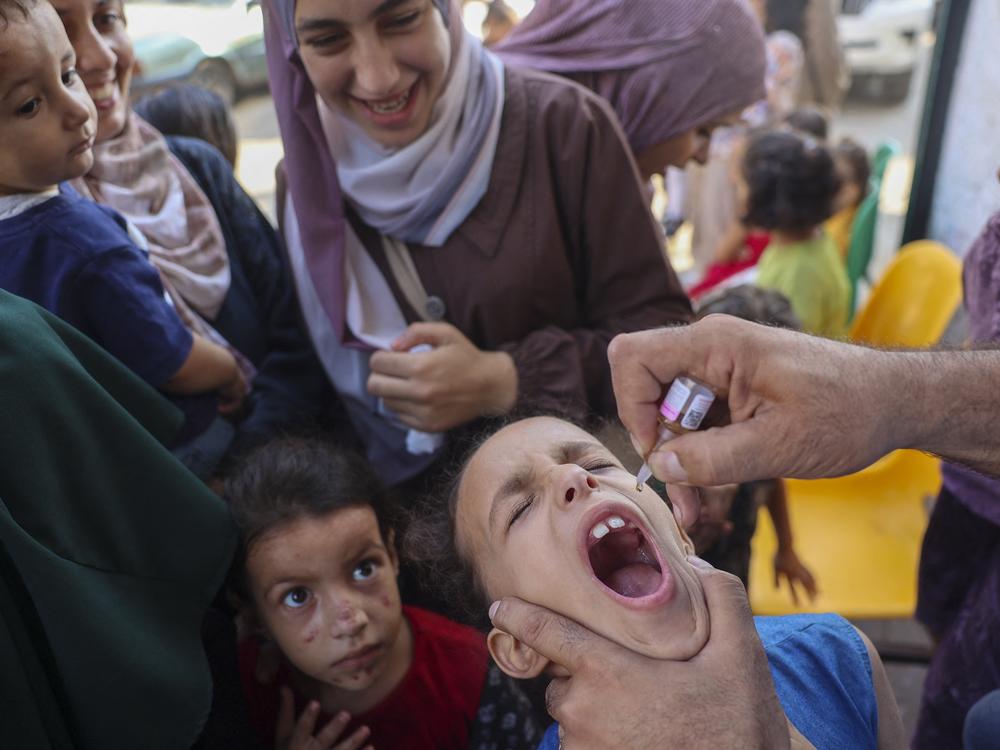 A health worker administers an oral polio vaccine in Zawayda, in the central Gaza Strip. The World Health Organization says that in less than two weeks, they’ve helped administer more than 550,000 polio vaccines to children across the enclave. Now they're gearing up for the second dose.