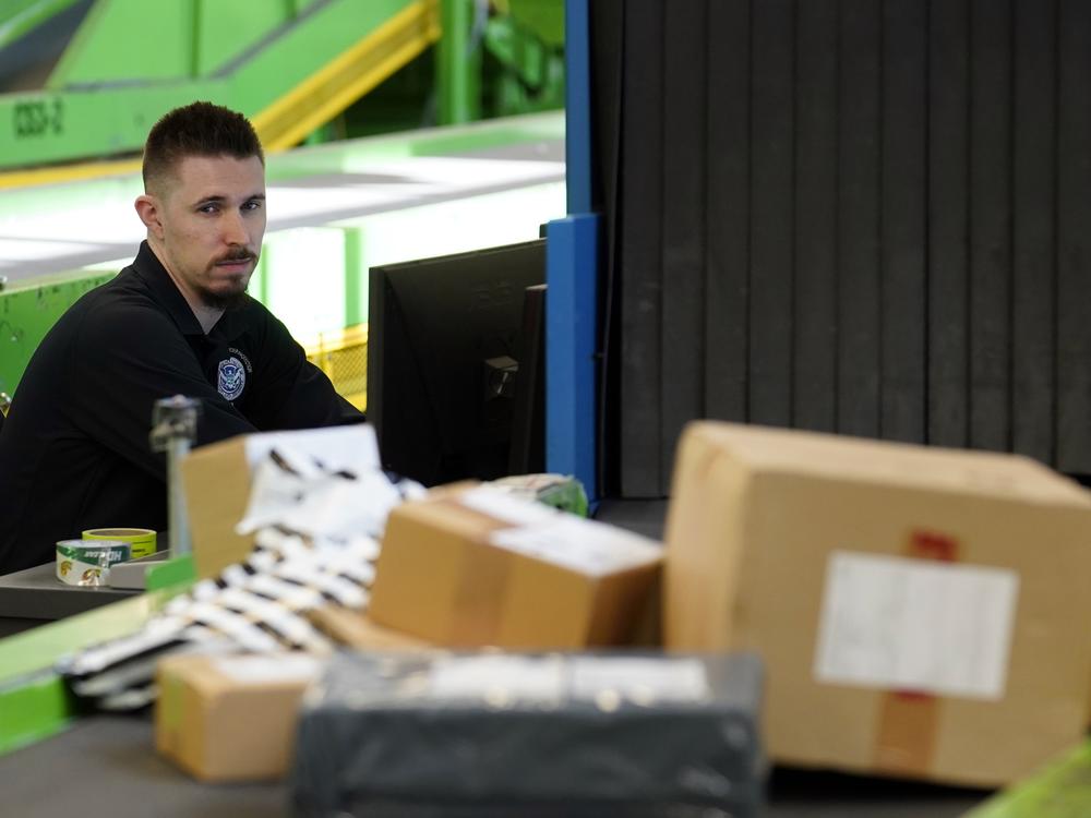 A U.S. Customs and Border Protection technician monitors overseas parcels as they get scanned at a mail inspection facility in Chicago.
