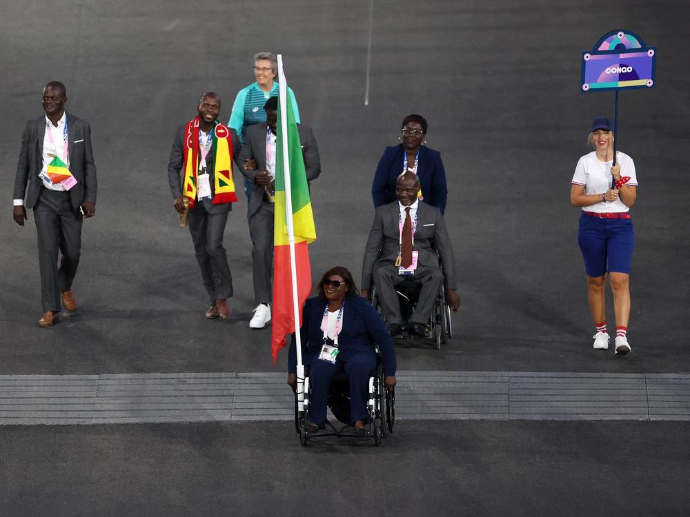 Emmanuel Grace Mouambako, second from left, and Mireille Nganga, center, were the flag bearers for Team Congo at the opening ceremony of the Paris 2024 Summer Paralympic Games at Place de la Concorde on Aug. 28, 2024. The two athletes and Mouambako's sighted guide have since gone missing. 