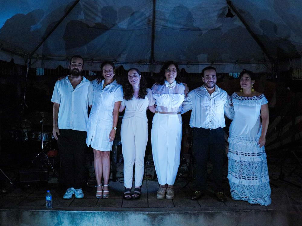 Pianist Daniela Santos, second from left, with the ensemble she was performing with when one of Puerto Rico's frequent power outages interrupted the Aug. 24 concert she'd worked six years to debut. Afterward, the musicians posed for a photo illuminated by cellphones from the audience.