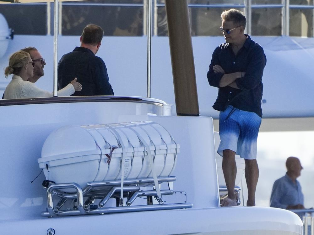 Lachlan Murdoch, right, with his wife Sarah and others as they watch a sailing regatta in Sydney, Australia in February.