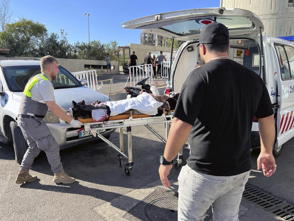 Civil Defense first-responders carry a wounded man whose handheld pager exploded at al-Zahraa hospital in Beirut, Lebanon, Tuesday, Sep. 17, 2024.