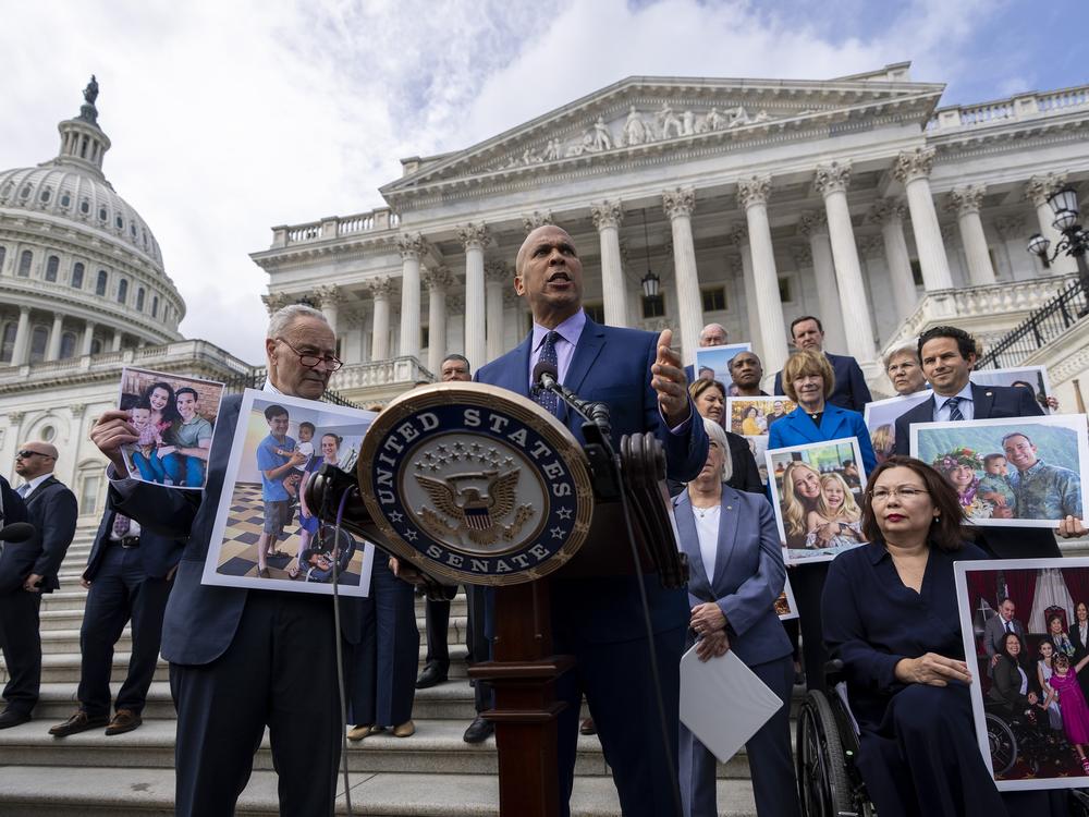 Sen. Cory Booker, D-NJ., accompanied by Senate Majority Leader Chuck Schumer, D-NY, left, and Sen. Tammy Duckworth, D-Ill., right, speaks about the need to protect rights to in vitro fertilization (IVF), before Senate vote on the issue.