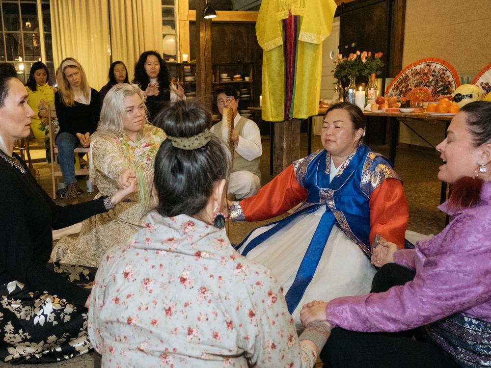 <em>In the Indigenous circle, Aká</em> <em>Hansen sings a traditional Inuit song.</em>