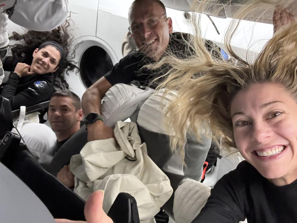 In this image posted by SpaceX following the first-ever commercial spacewalk by the Polaris Dawn crew, shows (L-to-R) mission specialist Sarah Gillis, commander Jared Isaacman, pilot Scott Poteet and mission specialist Anna Menon aboard a SpaceX Crew Dragon capsule.