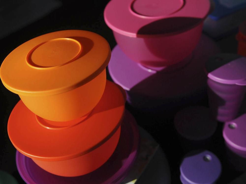 Colorful Tupperware products are displayed at a selling party in California.