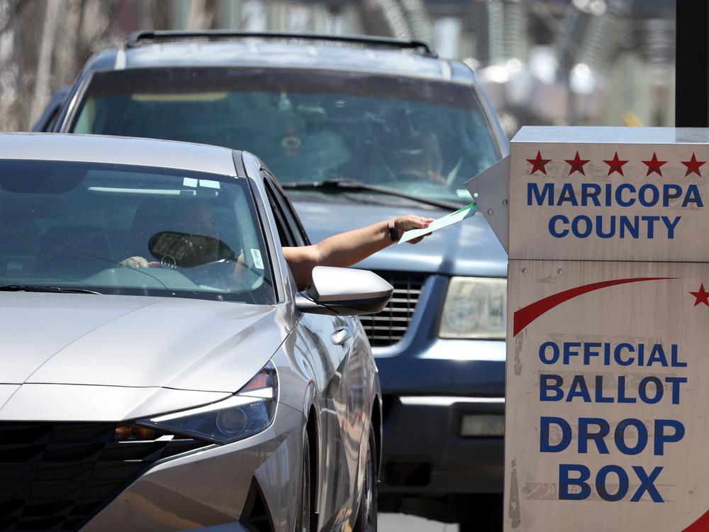 A voter places a ballot in a drop box outside of the Maricopa County Elections Department on Aug. 2, 2022 in Phoenix. A records flaw risks blocking nearly 100,000 people from voting in state and local races in Arizona in the upcoming elections.
