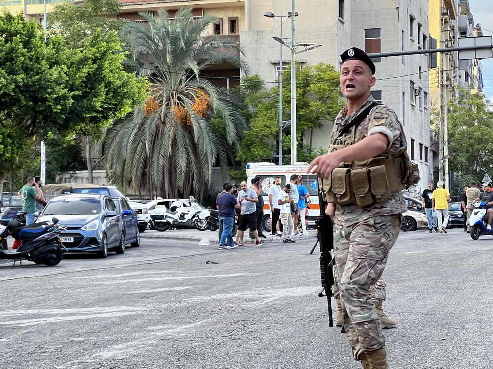 A Lebanese army soldier gestures at the scene of a reported pager explosion in Sidon, in southern Lebanon, on Wednesday. A second wave of deadly device explosions struck in Hezbollah strongholds of Lebanon, raising fears of an all-out war between Israel and the Iranian-backed militants.