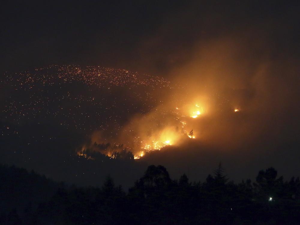 A fire burns on a hillside near Sever do Vouga, a town in northern Portugal that has been surrounded by forest fires, on Tuesday.