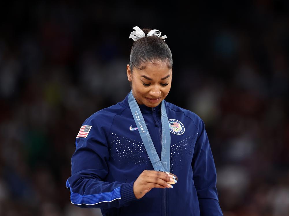 American gymnast Jordan Chiles admires her bronze medal after the women's floor final at the Paris Summer Olympics on August 05, 2024. On Monday, her attorneys filed a formal appeal with a Swiss court after a delayed appeal led to the stripping of her medal.