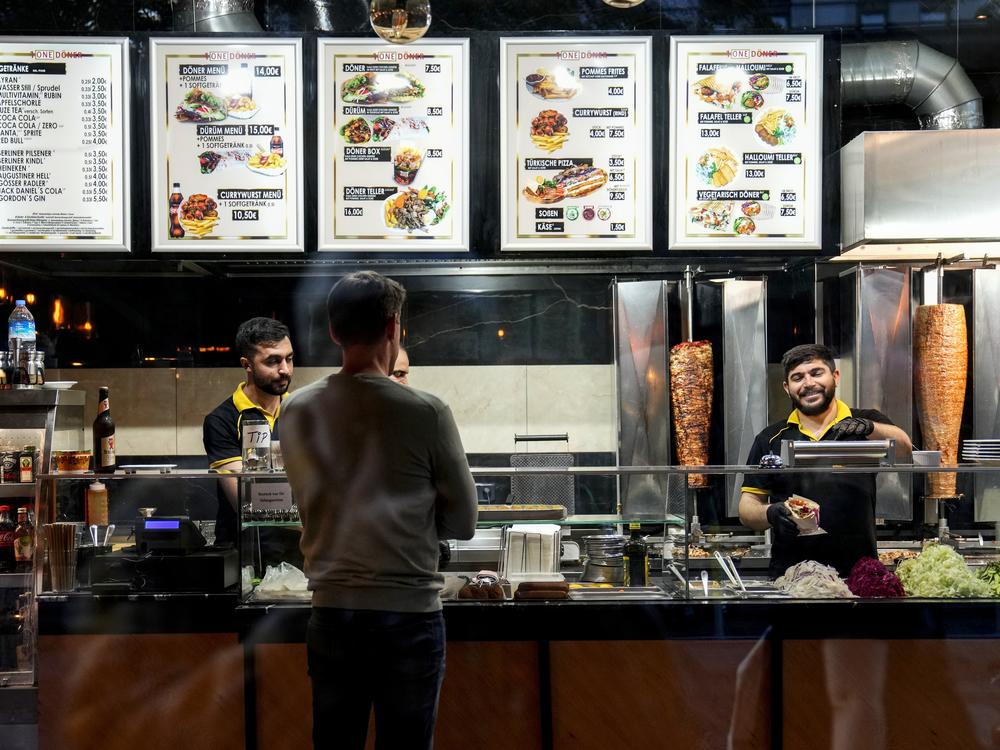 Turkish doner cooks prepare doner kebabs for customers in a doner kebab restaurant in Berlin, Germany, on Wednesday.