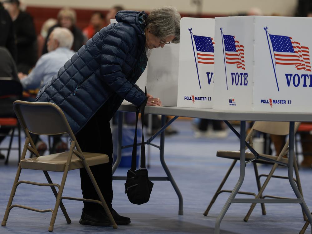 A voter fills out their New Hampshire presidential primary ballot at a polling location in Bedford on Jan. 23.