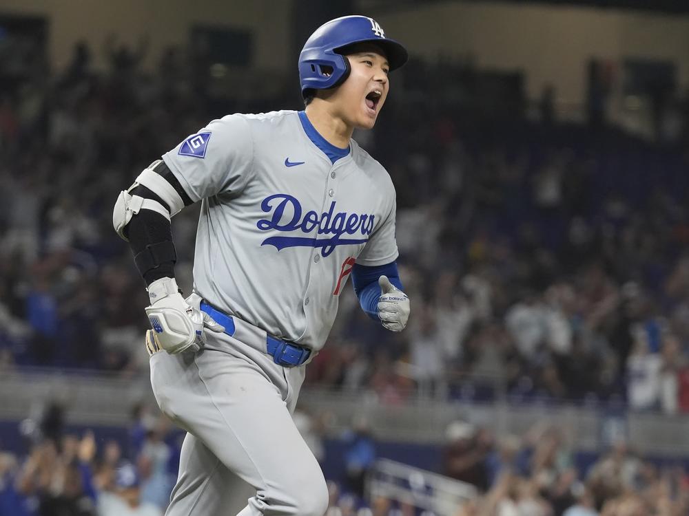 Los Angeles Dodgers' Shohei Ohtani reacts after hitting his 50th home run of the season during the seventh inning of a baseball game against the Miami Marlins on Sept. 19, 2024, in Miami. 