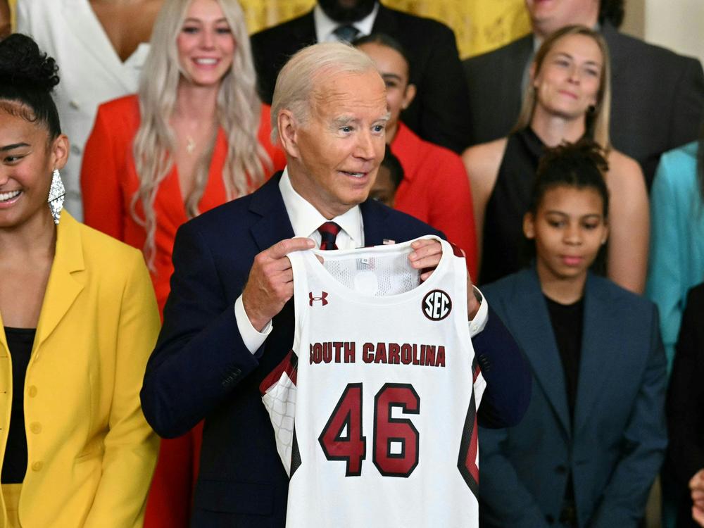 President Biden holds a jersey given to him by the University of South Carolina women's basketball team during a White House event to celebrate their 2023-24 championship season on Sept. 10, 2024.