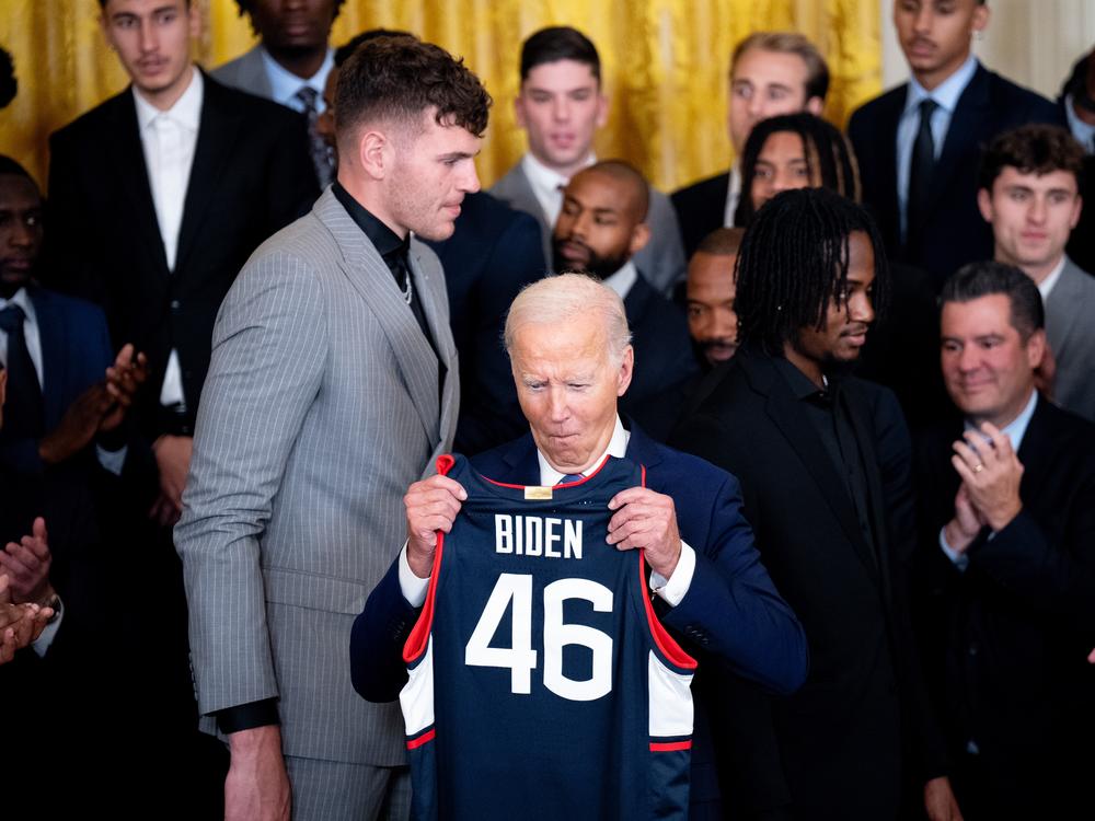 University of Connecticut Huskies basketball players present President Biden with a jersey during a celebration of their NCAA championship season at the White House on Sept. 10, 2024.