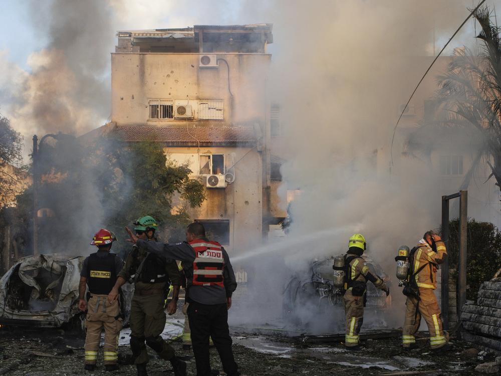 Israeli security and rescue forces work at the site hit by a rocket fired from Lebanon, in Kiryat Bialik, northern Israel, on Sunday, Sept. 22, 2024.