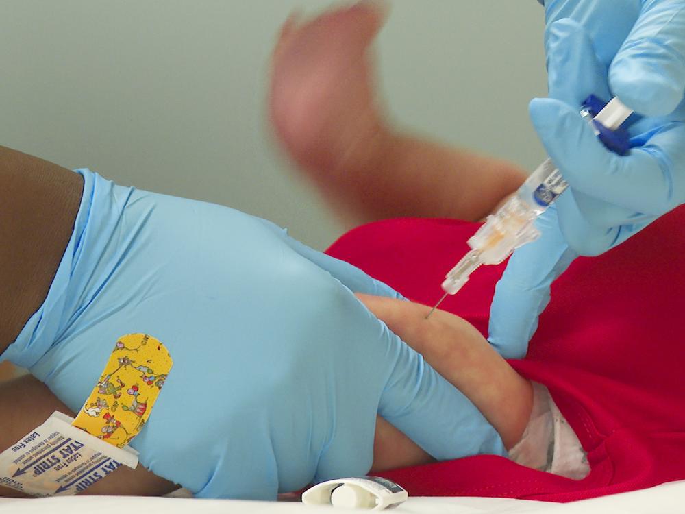 An infant receives a routine vaccination at First Georgia Physician Group Pediatrics in Fayetteville, Ga., in 2021.  Infectious diseases experts say children didn't stay up to date on their whooping cough vaccinations due to decreased in-person care during the pandemic.