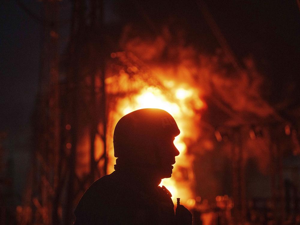 A Ukrainian rescue worker looks on at a burning electrical substation hit by a Russian bomb in the Dnipropetrovsk region in eastern Ukraine on Sept. 2. 