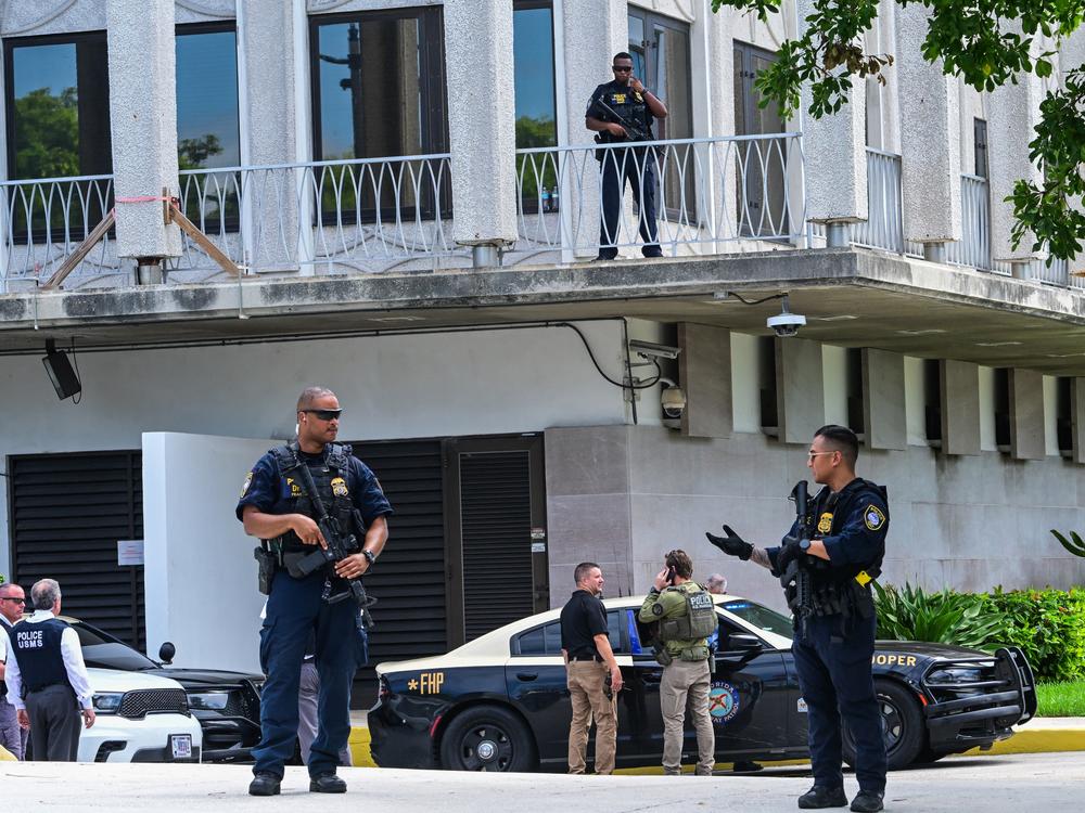 Federal police officers and other law enforcement officials stand watch Monday outside the federal courthouse during a hearing on the detention of Ryan Routh, suspected of the attempted assassination of former U.S. President Donald Trump, in West Palm Beach, Fla., on September 23, 2024.