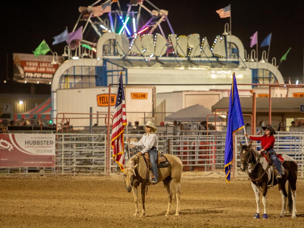 Flag bearers at the Pahrump Fall Festival Rodeo hold the United States and Nevada flag.
