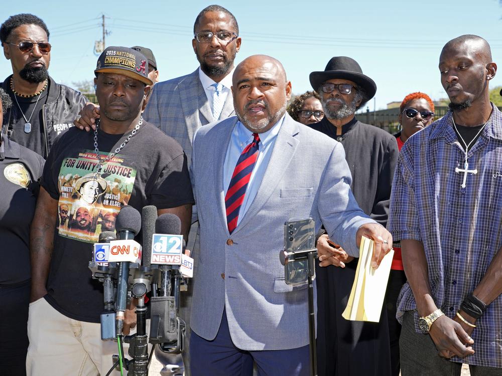 Michael Corey Jenkins (right) and Eddie Terrell Parker (left) stand with their local attorney, Trent Walker, at a news conference on March 18 in Jackson, Miss.