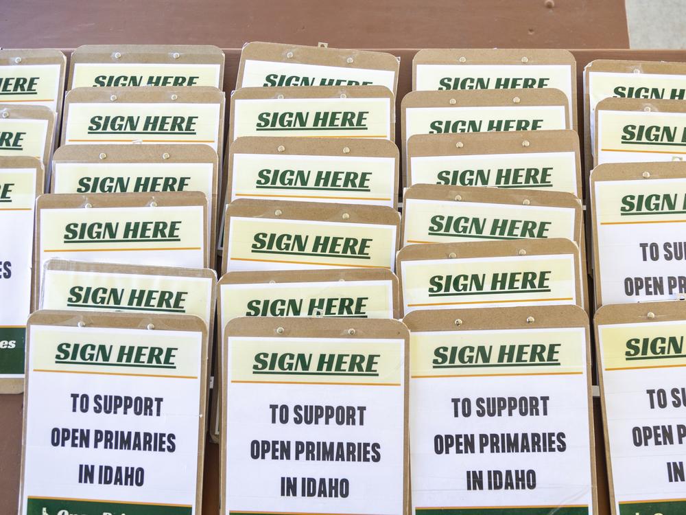 Clipboards for volunteers supporting the Idaho nonpartisan primaries ballot initiative fill a table during a gathering at Ivywild Park in Boise on April 27.