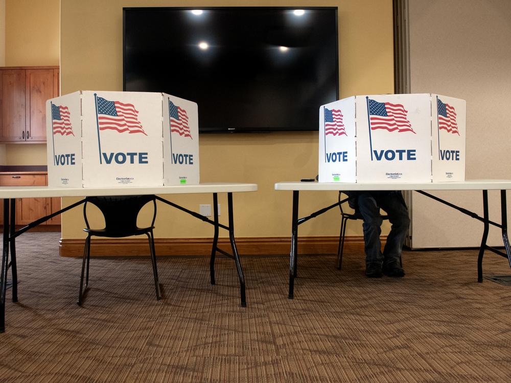 A voter casts his ballot at the South Branch Library during the presidential primary in Breckenridge, Colo., on March 5.