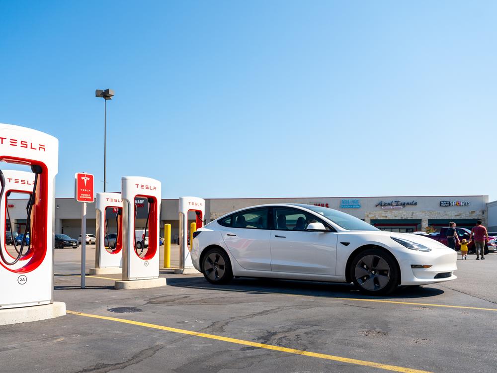 Tesla Superchargers stand in a parking lot in Austin, Texas, on Sept. 16. Electric vehicles have significant environmental advantages over similar gas-powered vehicles, but the percentage of Americans who believe so has gone down slightly over the last two years.