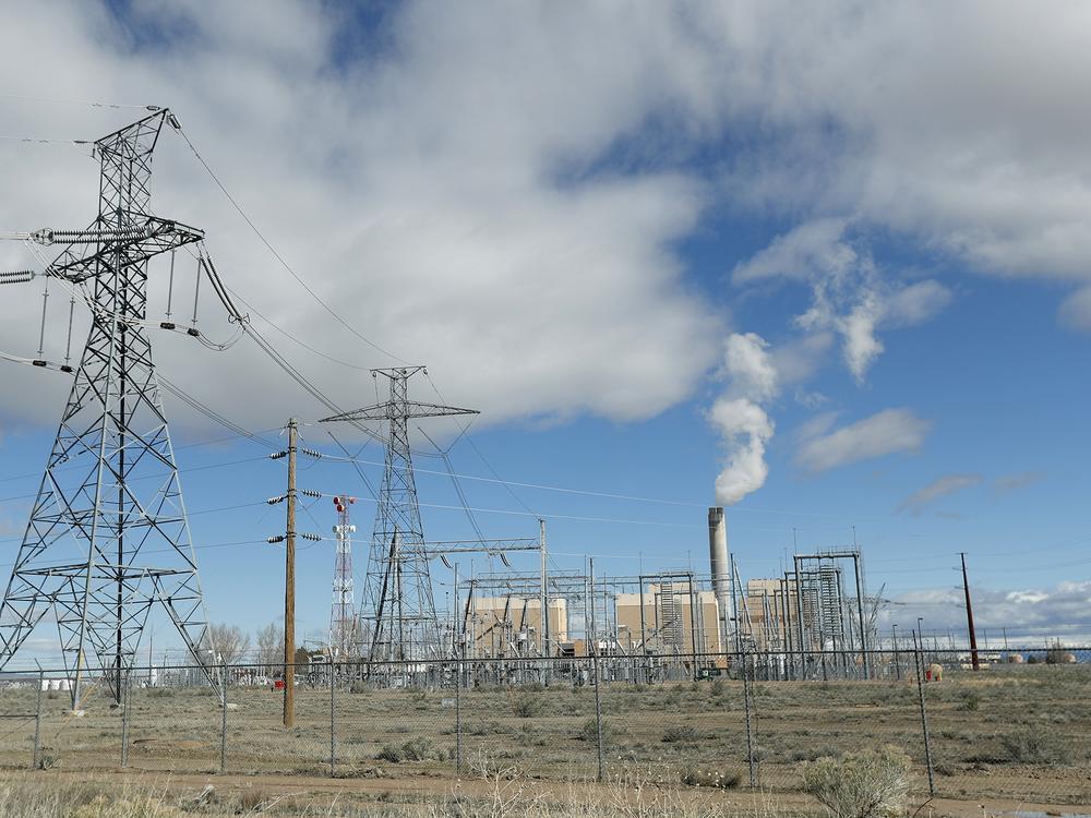Power lines lead into the coal-fired Intermountain Power Plant outside Delta, Utah. The plant, which is getting new turbines that can burn natural gas and hydrogen, is at the center of an ambitious project to cut greenhouse gas emissions.