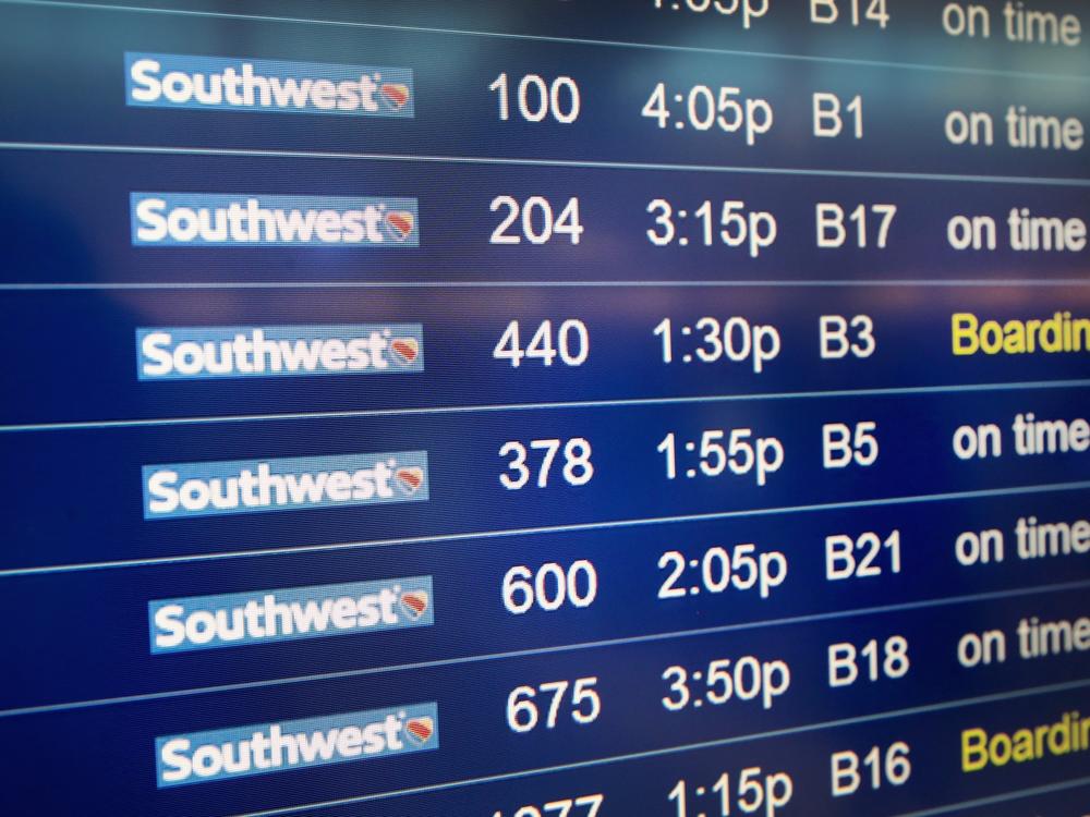Southwest Airlines flights are listed on a departure board at Midway Airport in Chicago. The carrier is moving away from its open seating policy for the first time in 50 years and changing to assigned seats.
