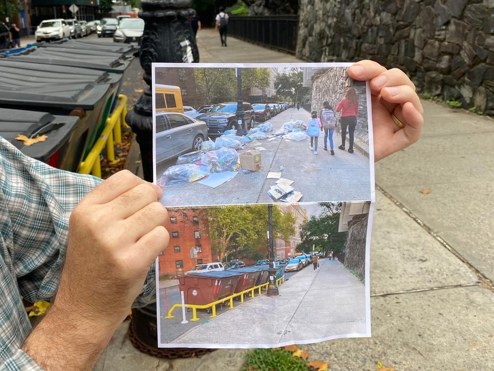 The city launched a pilot program in West Harlem last September, in which people dumped their trash into large fixed containers along curbs. Carl Mahaney, who lives in the area, holds a piece of paper with images of what one sidewalk looked like before and after the pilot bins were installed.