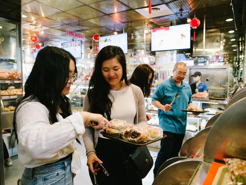  Sarah and Kaitlin Leung develop recipes with their parents for their blog, <em>The Woks of Life</em>. 