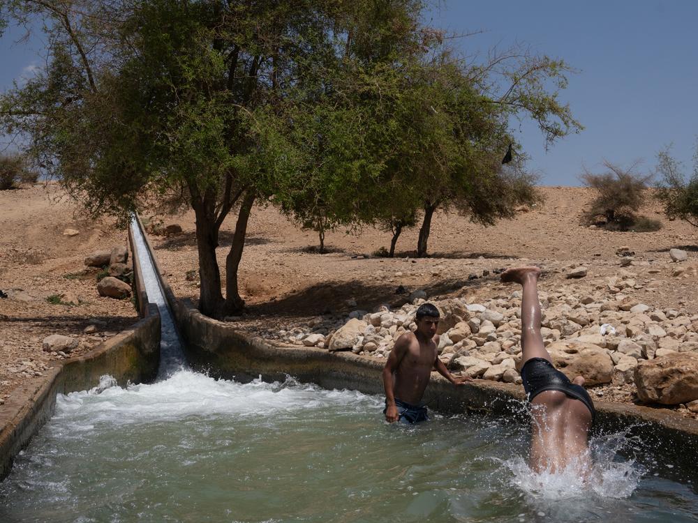 Children play in spring water in Al-Auja, a town in the occupied West Bank. 