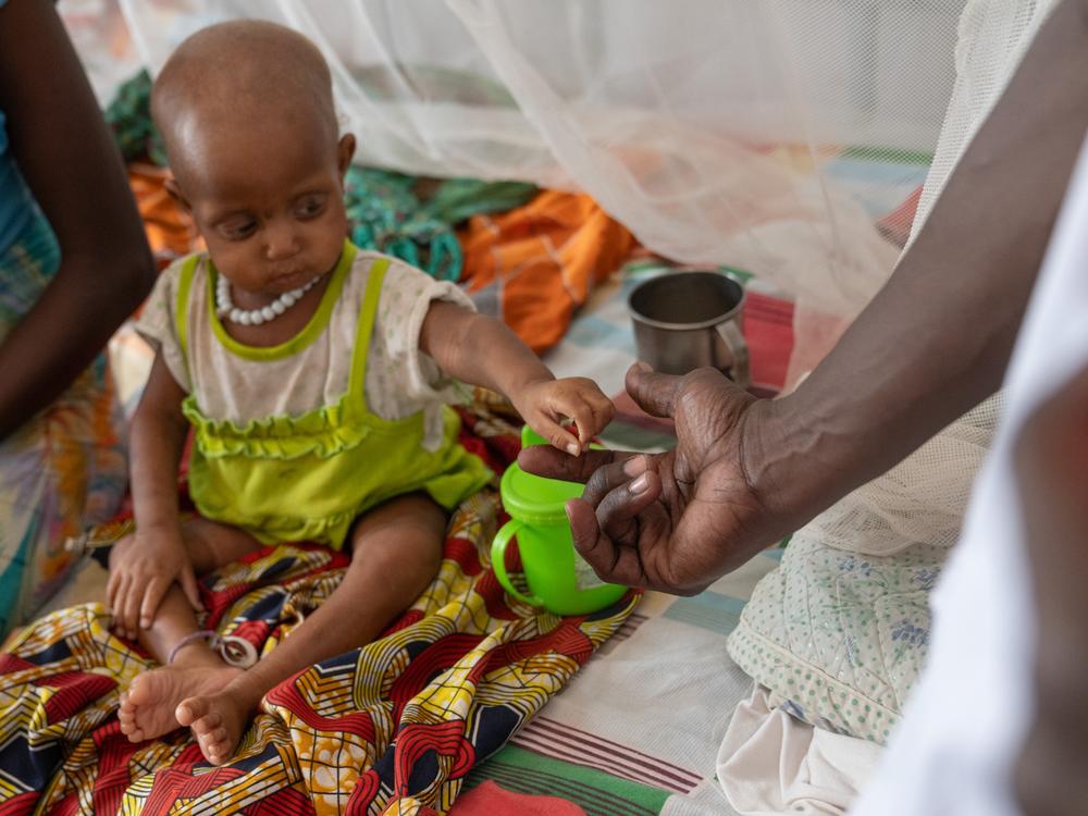 Halima Ali Adam, A chadian woman lives near Farchana, sits with her baby, Iqbal Abubakr Yaqub, who is 15 months old, at the malnutrition clinic. They've been there for 13 days and seen little improvement in the baby's condition.