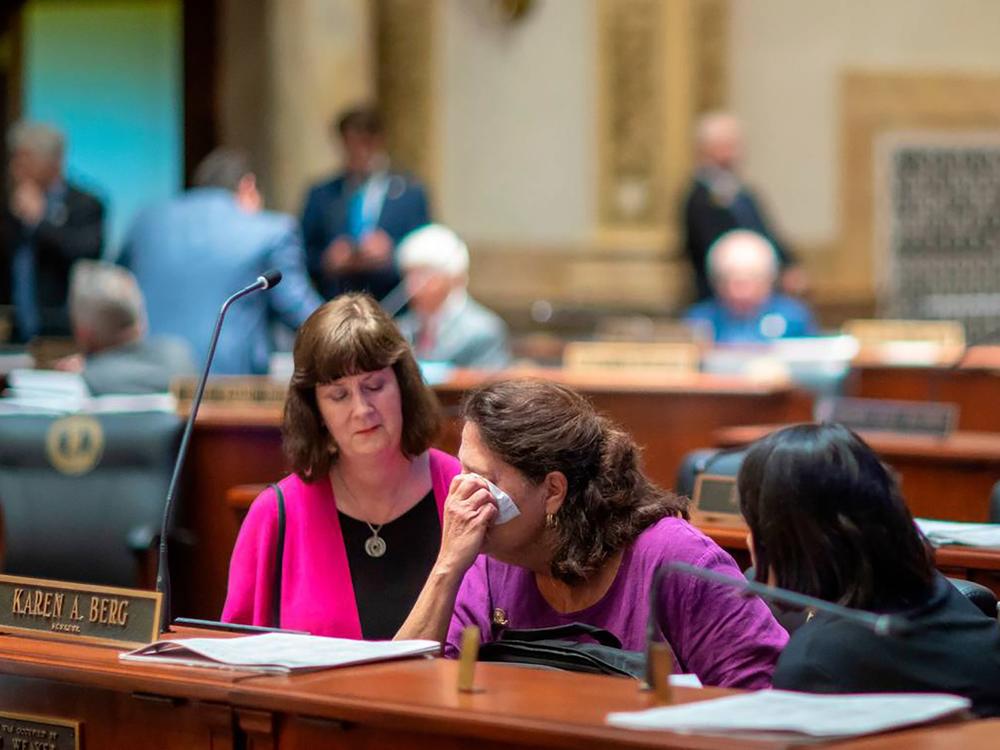 Kentucky state Sen. Karen Berg (D-Louisville), is consoled by colleagues after SB 150 passed the Senate, 29-6, at the Kentucky state Capitol in Frankfort on Feb. 16, 2023. Berg's transgender son died by suicide in December 2022. 