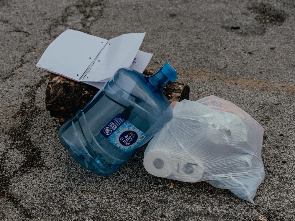 Supplies are left in a parking lot for those living in a tent encampment in Chicago's Gompers Park.