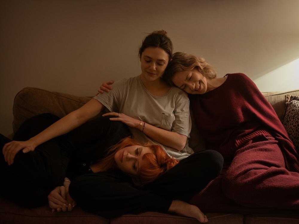Natasha Lyonne, left, Elizabeth Olsen and Carrie Coon play sisters who come together in the final days of their father's life in <em>His Three Daughters.</em>