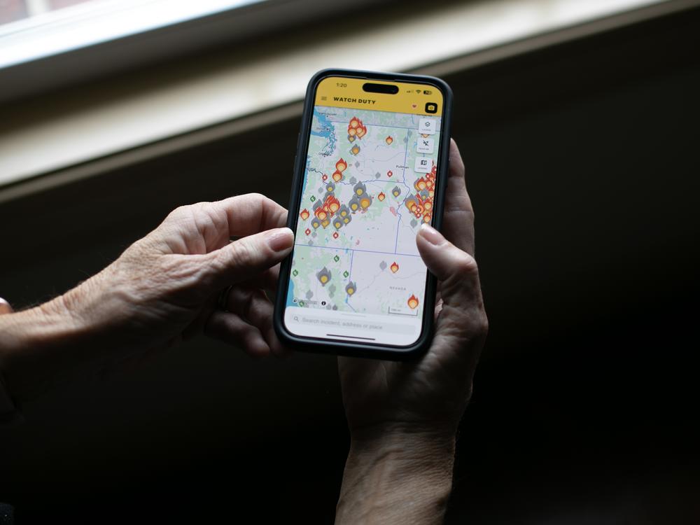 Watch Duty organizes information on a map of the U.S., which is dotted with flame icons representing active wildfires. Click a flame, and details like evacuation zones, fire lines, containment percentage, and acres burned pop up. Choose to track a fire, and you’ll get push notifications for the most urgent updates, like new evacuation orders.
