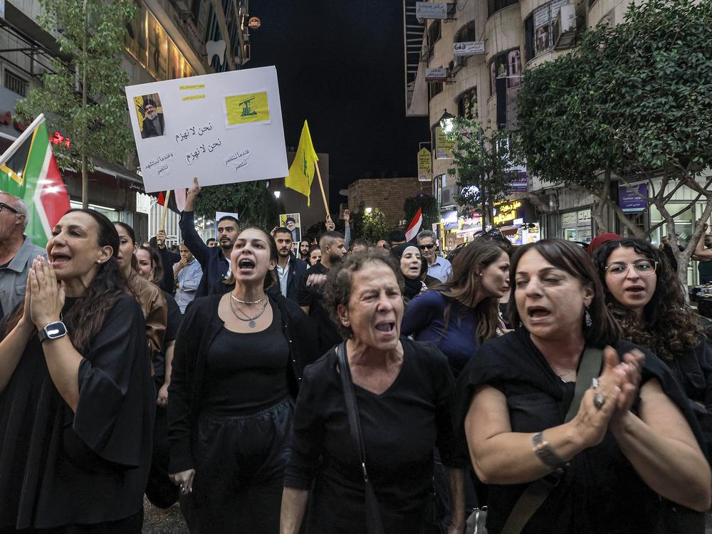 Demonstrators chant slogans while marching in a protest in the city of Ramallah in the occupied West Bank on Saturday, after Hezbollah confirmed reports of the killing of its leader Hassan Nasrallah in an Israeli airstrike.