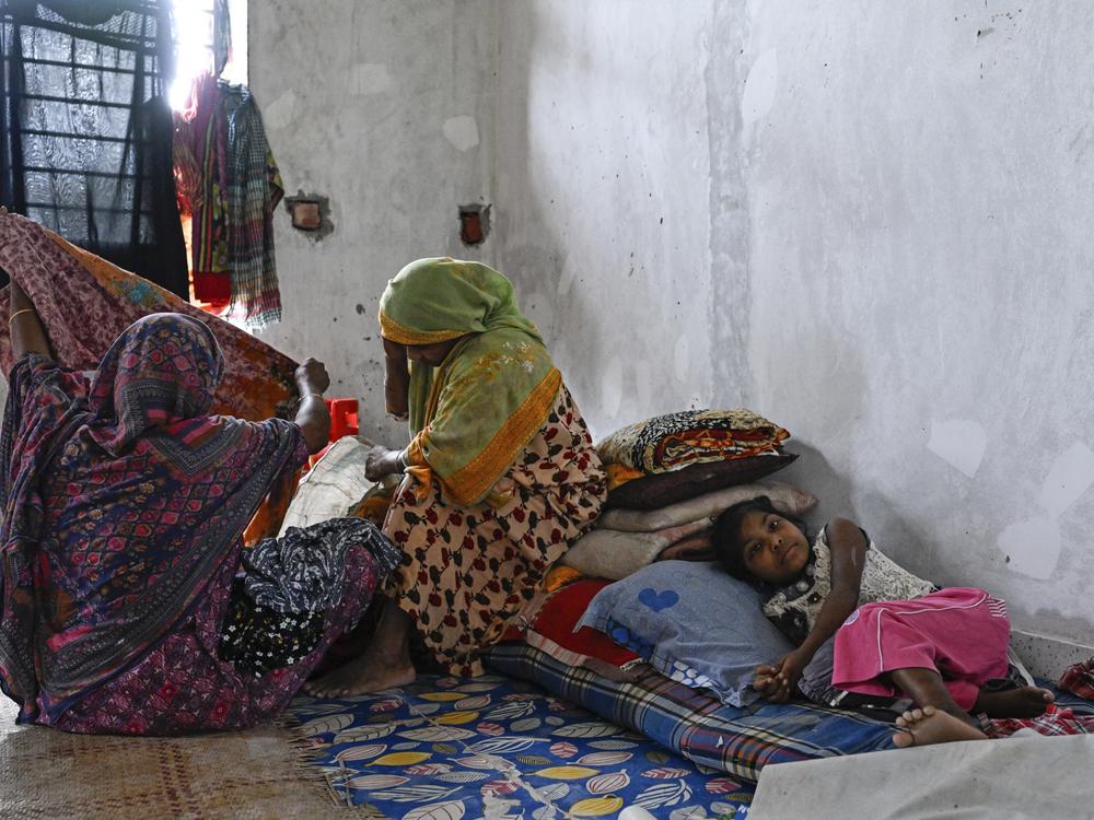 People displaced by floods rest at a relief shelter in Mohipal, Feni, a coastal district in southeast Bangladesh on August 23.