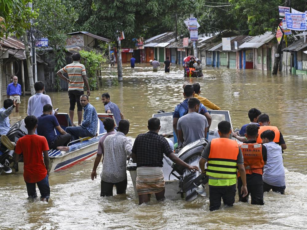 Volunteers take a motor boat to rescue people stranded in flooded residential areas in Feni, a coastal district in southeast Bangladesh on August 24, after heavy rains caused large areas to be flooded in Bangladesh.