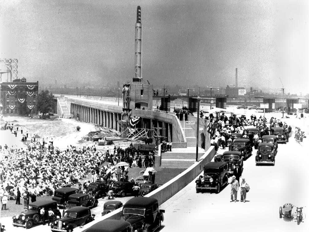 The Triborough Bridge, the new thoroughfare connecting Manhattan, the Bronx, and Queens, is officially opened in ceremonies held on Randall's Island, New York, July 11, 1936.  In attendance is Robert Moses, along with President Franklin Roosevelt, New York Gov. Robert H. Lehman and New York City Mayor Fiorello La Guardia.